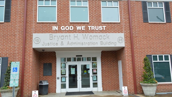 Polk County’s Womack building received the words “In God We Trust” on Thursday, March 31. The U.S. Motto Committee installed the wording both on the outside of the building and in the commissioner meeting room upstairs. (Photo by Leah Justice) 