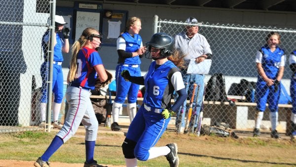 Polk County's Hayley Fowler (#6) has just crossed the plate on a sixth-inning double by Hayley Kropp, in Tuesday’s game between the Wolverines and Madison. Madison edged Polk, 2-1. (Photo by Mark Schmerling)