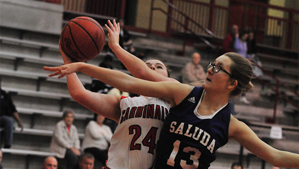 Landrum’s Ellen Boatwright (#24) has to figure a way around the right arm of Saluda’s Andrea Coats (13).