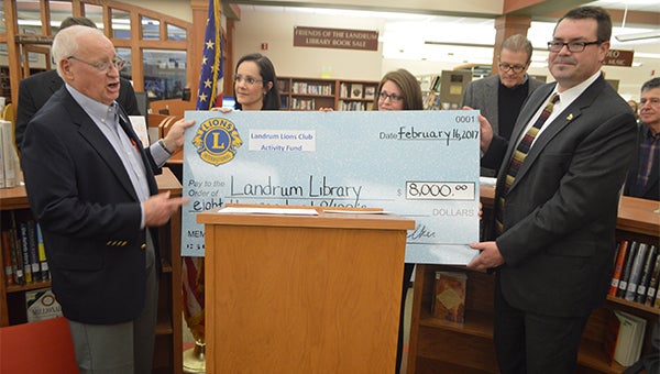 Bob Walker and Gerald McCool presented a check for $8,000 to the Landrum Library. (photos by Michael O’Hearn)