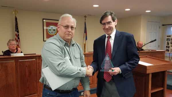 Columbus Mayor Eric McIntyre presented outgoing town attorney Bailey Nager with an award for his service on Thursday, Feb. 16. Nager resigned as the town’s attorney after serving since 2006. Columbus hired Lora Baker as its new attorney. (photo by Leah Justice)